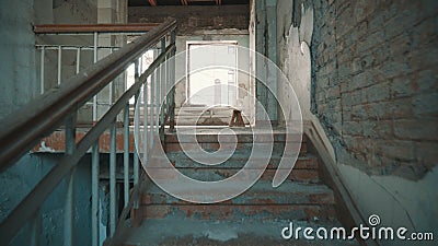 Destroyed school in Beslan after the terrorist attack. Old empty school corridors. The camera walks up the stairs. Stock Photo