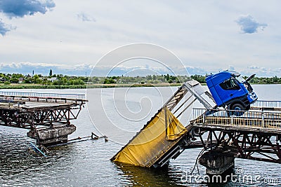 Destruction of bridge structures across the river with the collapse of sections into the water Stock Photo