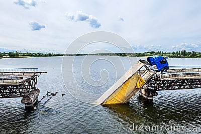 Destruction of bridge structures across the river with the collapse of sections into the water Stock Photo