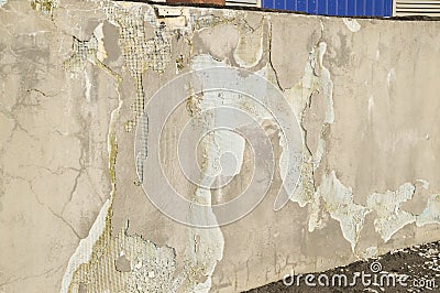 Destruction of plaster on the facade of an industrial building Stock Photo