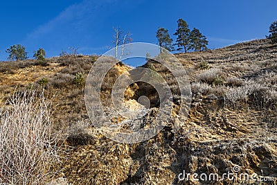 The destruction of the sandy river bank. Stock Photo