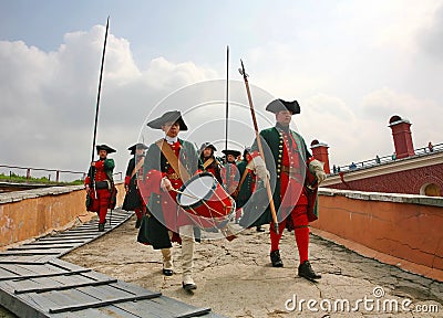 A detachment of historical reenactors in green and red uniform of the 18th century, markerwidth with weapons and drummer Editorial Stock Photo