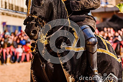Detail of the armor of a knight mounted on horseback during a display at a medieval festival Stock Photo