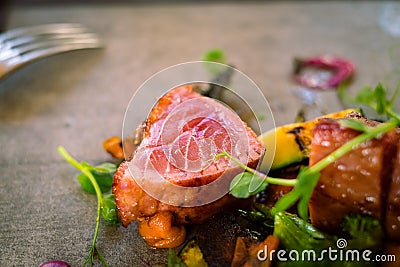 Detail of a medium roasted tuna steak served with microgreens Stock Photo