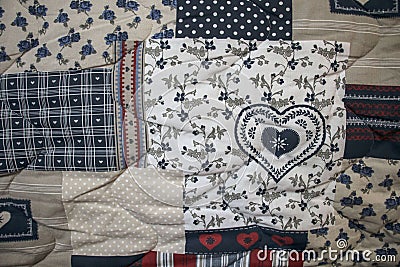 Detail of blue and white patchwork quilt with hand quilting Stock Photo
