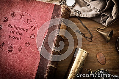 Detail book of world religions on table with vintage objects Stock Photo