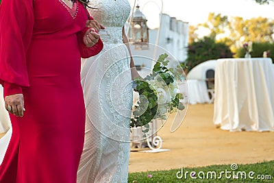 Detail of the bride's bouquet on the arm of her godmother before the wedding ceremony. Wedding concept, bouquet, flowers, Stock Photo