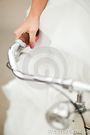 Detail of bride`s hand griping bicycle handle Stock Photo