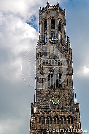 Detail of Bruges Belfry on sky with clouds background Stock Photo