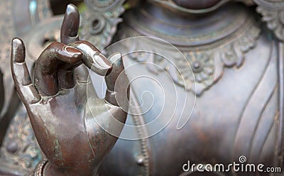 Detail of Buddha statue with Karana mudra hand position Stock Photo