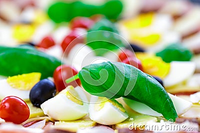 Detail buffet catering food with basil, olive, tomatoes, hamm, egg and others vegatables arangement on table Stock Photo