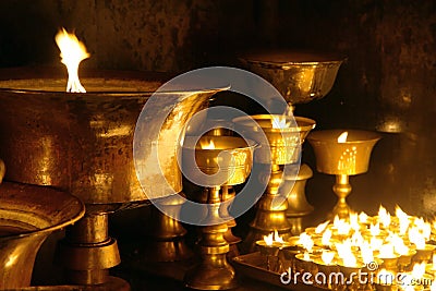 Detail of burning candles in buddhist monastery Stock Photo