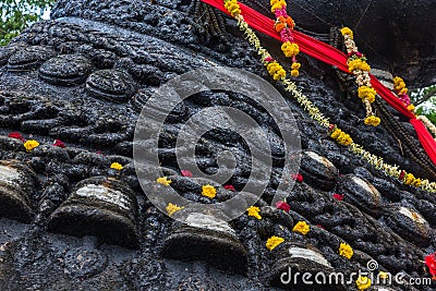 Detail carvings of bell on 350 year old monolithic statue of Nandi (Bull), Chamundi Hill, Mysore, India Stock Photo