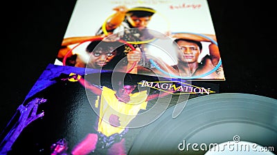 Detail of CDs and artwork by British trio Imagination. earning four platinum discs, nine gold discs and more than a dozen silver d Editorial Stock Photo