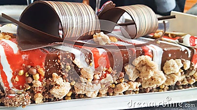 Detail of a Christmas buche of chocolate and red fruits with cramble Stock Photo