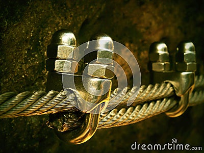 Detail of chrome screws snap hooks and grommets at and of rope. Iron twisted rope fixed together by screws snap hooks. Detail of Stock Photo