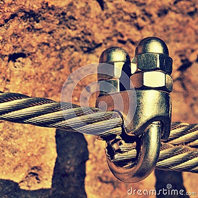 Detail of chrome screws snap hooks and grommets at and of rope. Iron twisted rope fixed together by screws snap hooks. Detail of Stock Photo