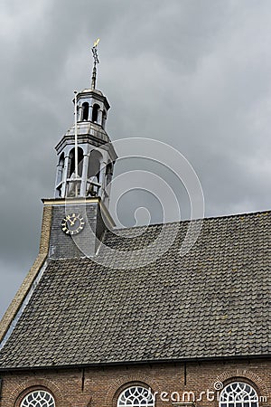 Detail of church in Ottoland, tower and clock against cloudy sky Stock Photo