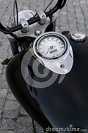 Detail of classic chopper motorcycle black tank with speedometer and chrome details Stock Photo
