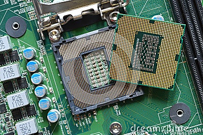 Detail of a CPU Processor over his Socket on a Motherboard. Printed Circuit Board - Computer Motherboard with Components. Close-up Stock Photo