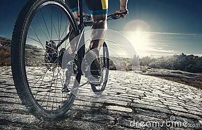 Detail of cyclist man feet riding mountain bike on outdoor trail on country road Stock Photo