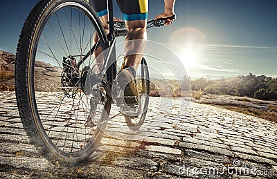 Detail of cyclist man feet riding mountain bike on outdoor trail on country road Stock Photo