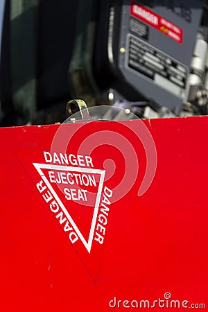 Detail of danger ejection seat warning sign on airplane Stock Photo