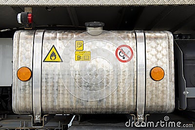 Detail of the diesel tank of a parked truck. Hazard labels are attached Stock Photo