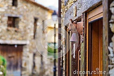 Detail of door bell with cow's head in old stone village. La Hiruela Madrid Stock Photo