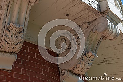 Detail of elaborate corbels beneath a curved balcony and brick wall Stock Photo