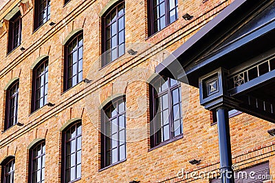 Detail of the facade of a modern loft-style office building, rebuilt from an old steam mill Editorial Stock Photo