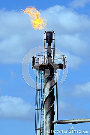 Detail of a flare tip and flame burning off excess gas. Stock Photo