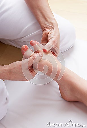Detail foot reflexology massage Stock Photo