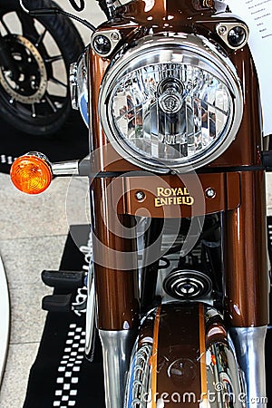 Detail of front mask with round headlight, front suspension fork and round orange winkers of indian made revival of british bike Editorial Stock Photo