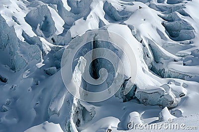 Detail of glacier flow and crevasses covered by snow in winter Stock Photo