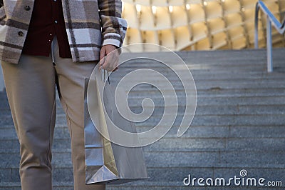 Detail hand of man holding paper shopping bag. Concept shopping and holidays Stock Photo