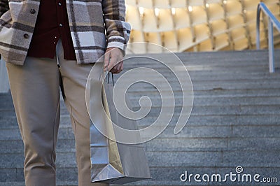 Detail hand of man holding paper shopping bag. Concept shopping and holidays Stock Photo