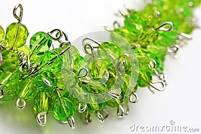 Detail of handcrafted plant like necklace from silver jewelry wire and green glass gems. Stock Photo