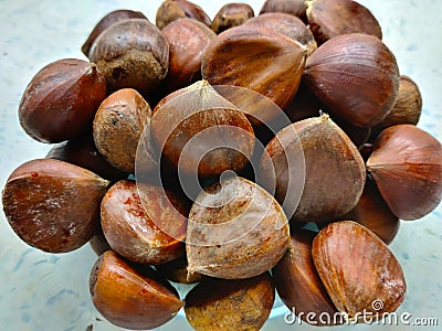 Detail of heap of sweet chestnut in the transparent bowl Stock Photo