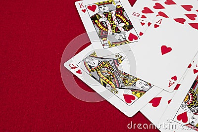 Detail of heart deck poker playing cars in red background Stock Photo
