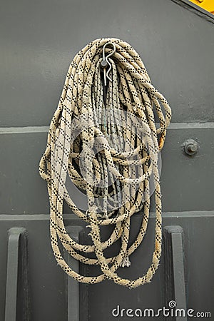 Detail of a hook with a rope leaning over it inside a port Stock Photo