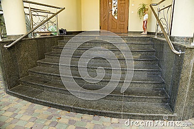 Detail of a house facade. New granite stairs with metal railings Stock Photo