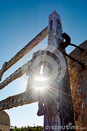 detail of iron lock on typical wooden door with lichens on stone wall next to on the way with beautiful blue sky and starry Stock Photo