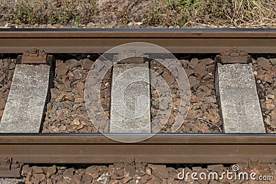 Detail iron rails of the train between rocks Stock Photo