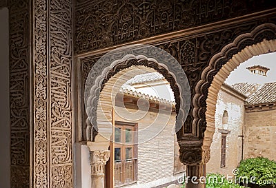 Detail of Islamic calligraphy on arches of the 14th century fortress complex of Alhambra, in medieval arabic style Stock Photo