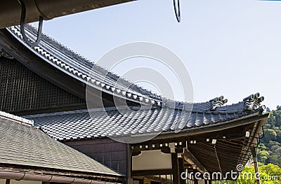 Detail on japanese temple roof against blue sky Stock Photo