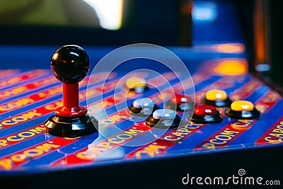 Detail on a joystick and six button controls of a blue arcade game Editorial Stock Photo