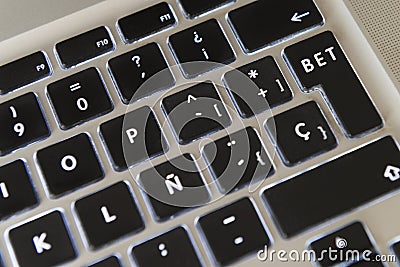 Detail of the keyboard of a laptop in which the ENTER key has been modified to include the word BET Stock Photo