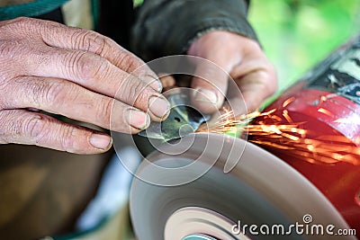 Detail of knife grinding with selective focus Stock Photo