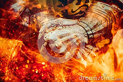 Detail knight armor. Gloves of a knight. Fire effect. Stock Photo